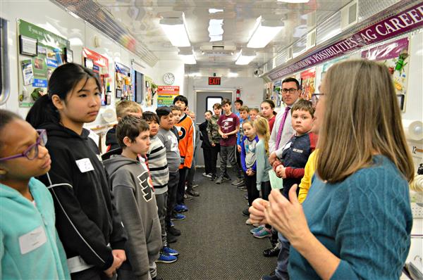 5th-grade students listen to instructions before making glue out of milk 